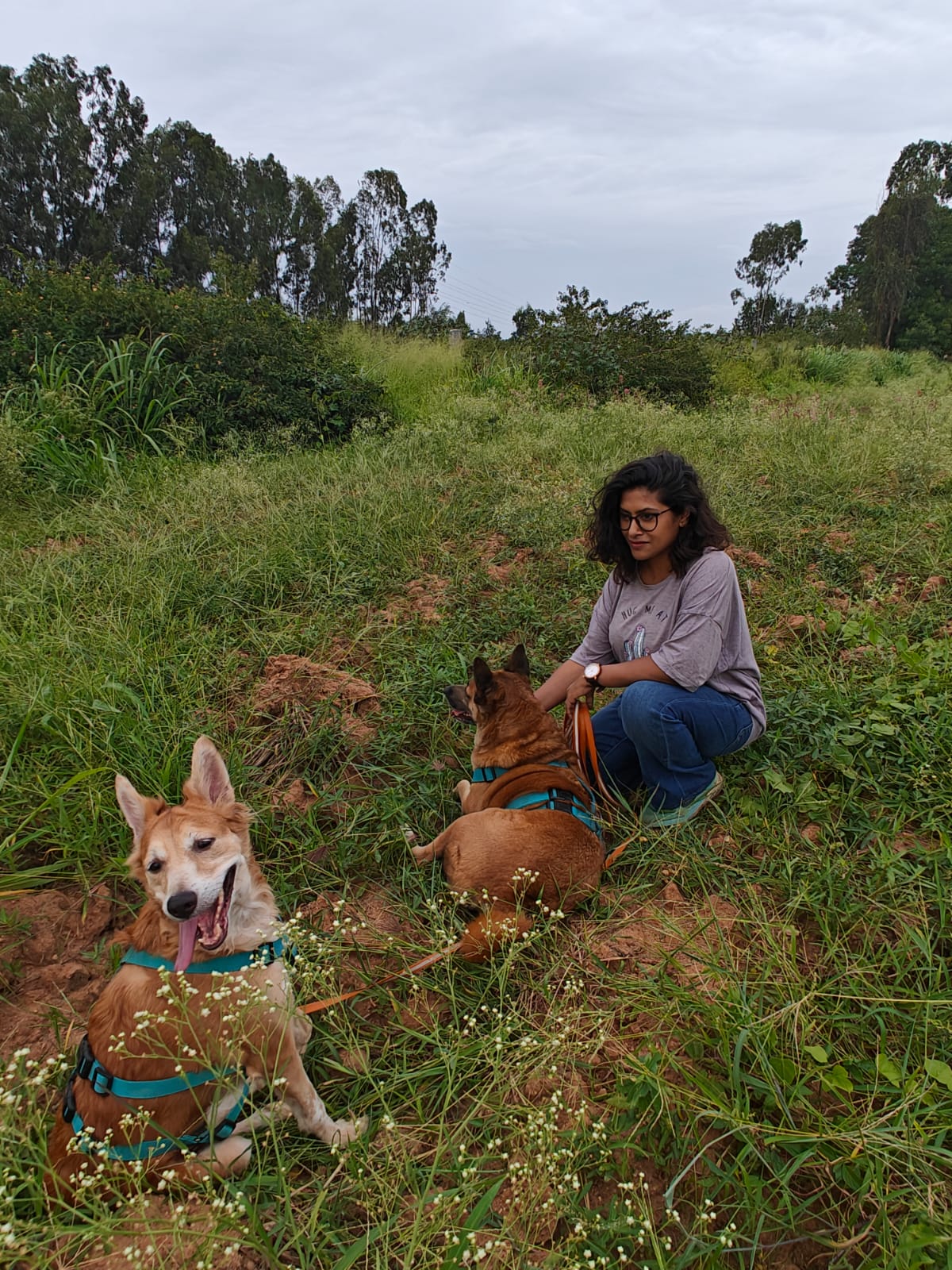 Founder, an Indian woman, with her two rescued dogs, Walnut and Kai, in the great outdorrs